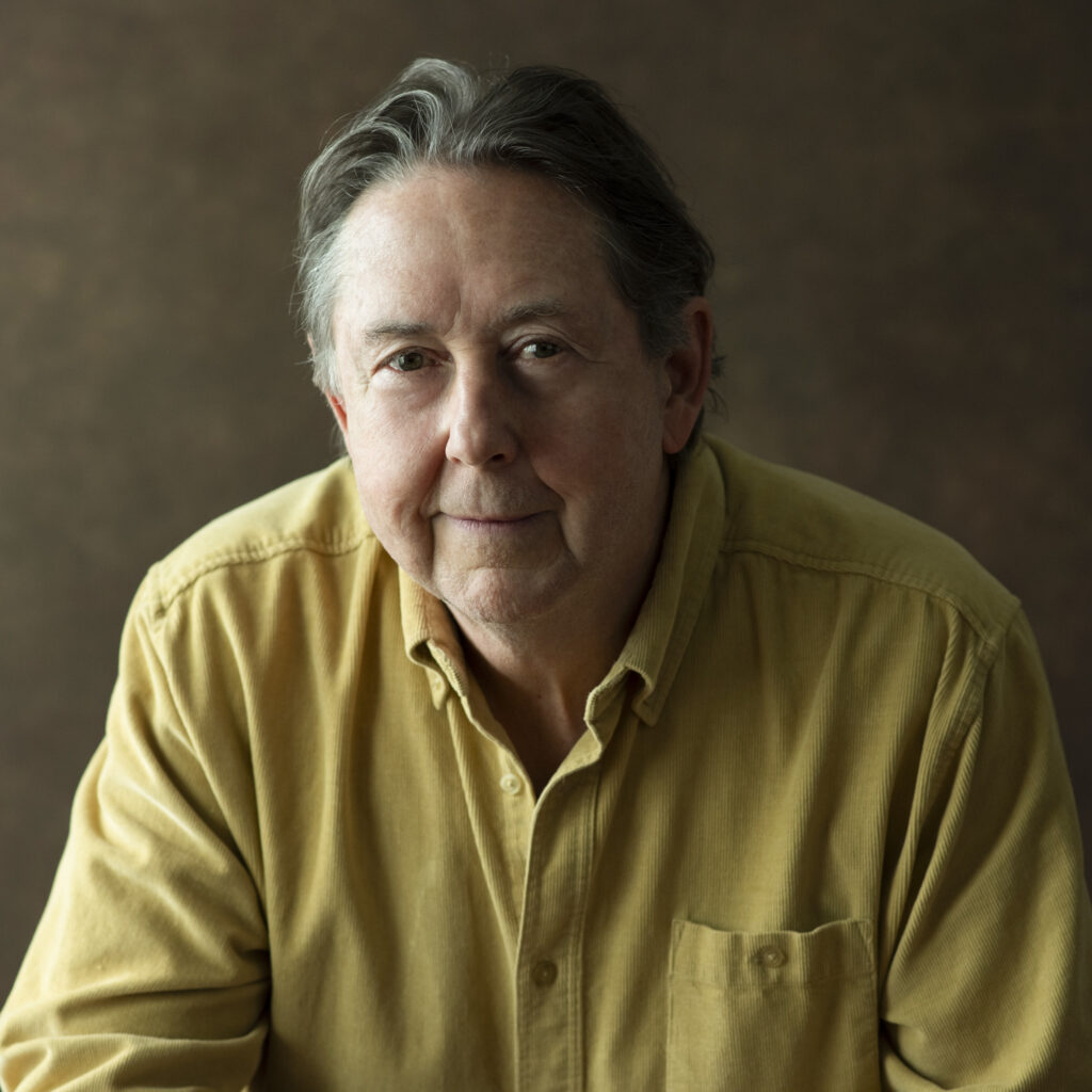 Mark Anthony Burke poses for a portrait in a black shirt, showcasing his deep and rich voice as a music artist.